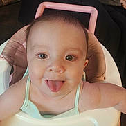 Tatyana is registered to the contest to win money with this photo: baby, child, clothing, cute, expression, face, happy, head, highchair, indoors, infant, person, pink, playful, seat, skin, smiling, tongue, tongue_out, young