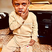 Matthew joined the competition — help win amazing prizes! child, tearful, distressed, beige_clothing, tracksuit, kitchen, counter, appliance, sitting, face, hand, sweatshirt, pants, expression, indoor, person, young_child, clothing_brand, emotional, portrait