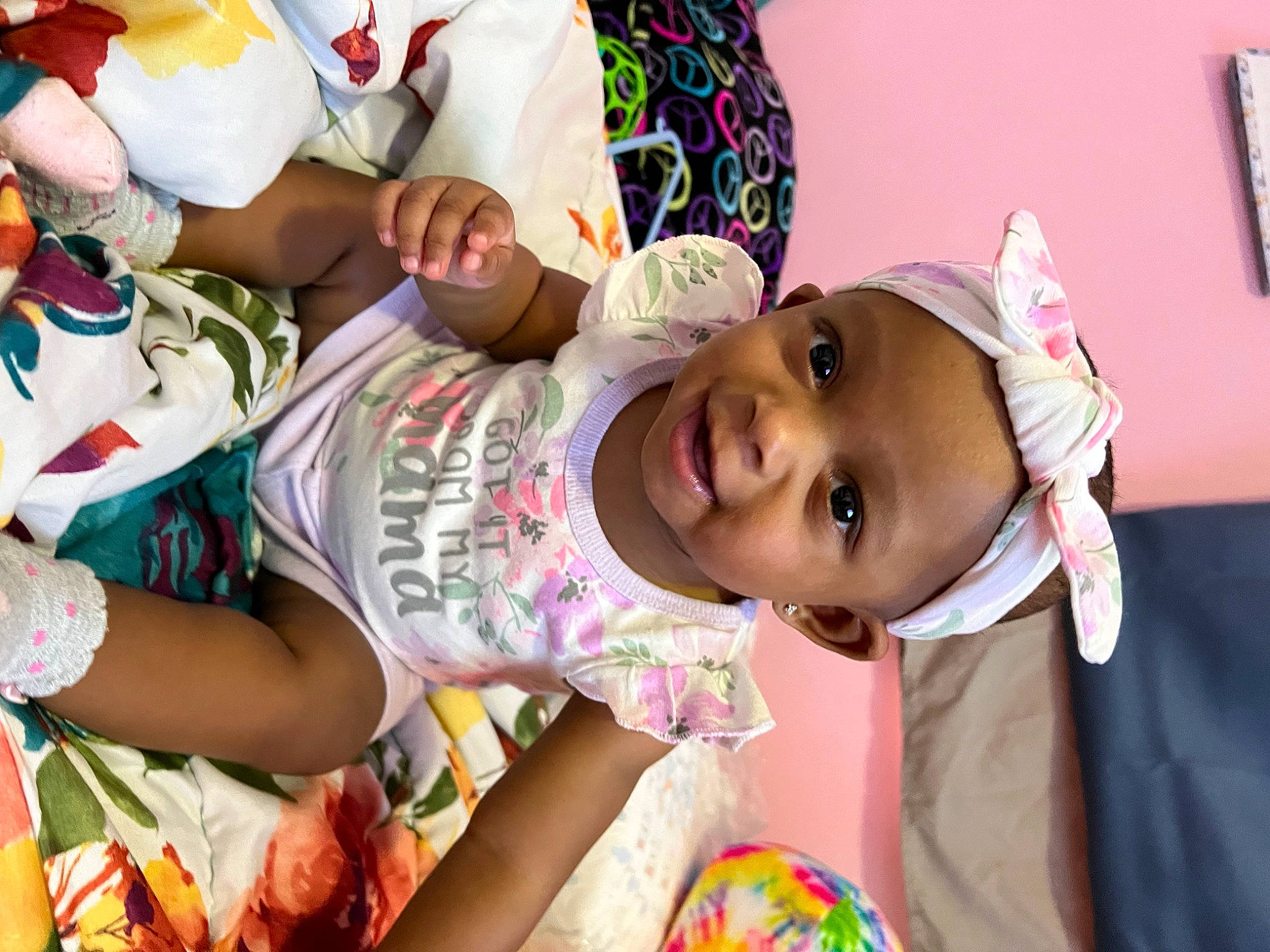 Amira is registered to the contest to win money with this photo: baby, child, community, eye, face, facial_expression, fun, happy, hat, head, headgear, human, leg, mammal, person, pink, skin, smile, sun_hat, textile