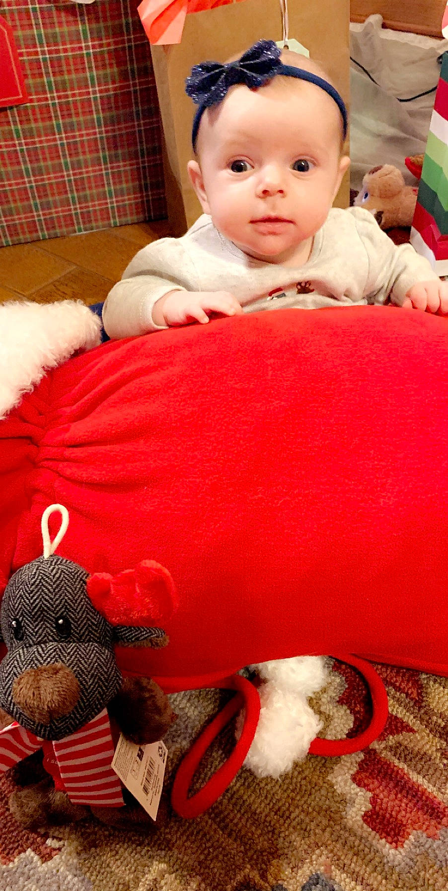 Remi is registered to the contest to win money with this photo: baby, bedtime, blanket, cheek, child, christmas, nap, person, play, red, skin, stuffed_toy, toddler, toy