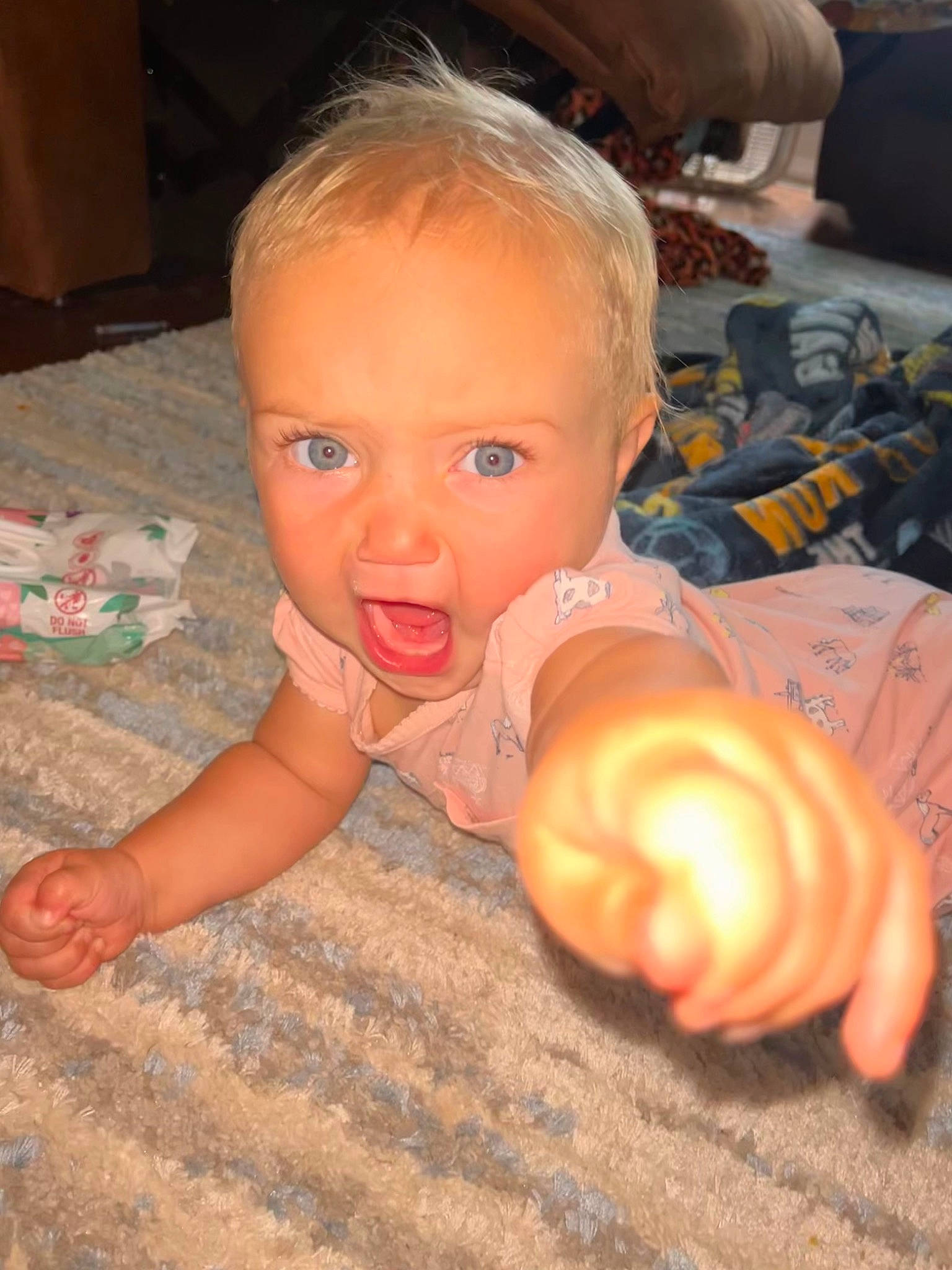 Lauryn is registered to the contest to win money with this photo: baby, cheek, chest, child, ear, finger, floor, flooring, fun, gesture, hand, human_body, joint, mouth, nail, nose, person, skin, thumb, toddler