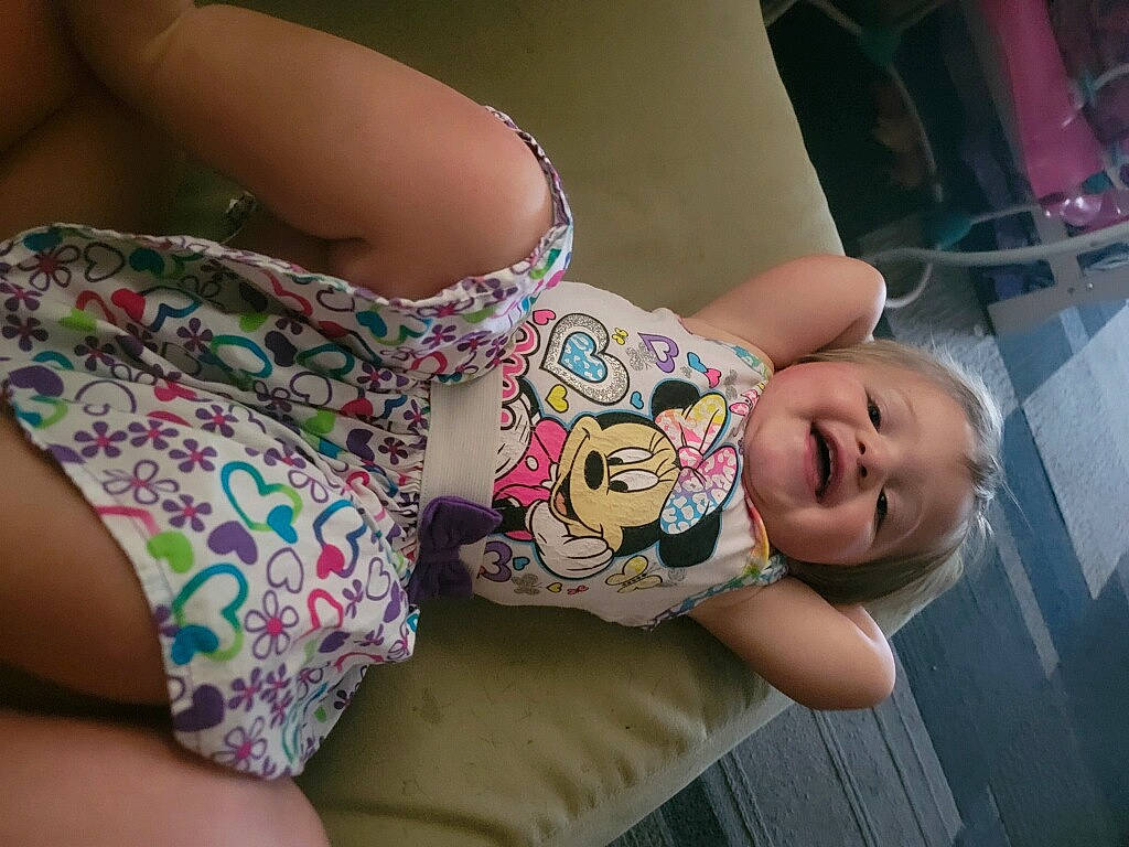 Zara is registered to the contest to win money with this photo: baby, baby_toddler_clothing, cheek, child, comfort, dress, eye, eyelash, finger, glasses, happy, head, human_body, joint, mouth, person, pink, skin, thigh, toddler