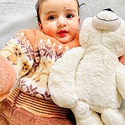 Jujhar joined the competition — help win amazing prizes! baby, child, teddy_bear, plush_toy, sweater, patterned_clothing, brown_pants, soft_texture, cuddly, cute, indoor, portrait, smiling, happy, infant, closeup, cozy, warm_clothing, white_background, person