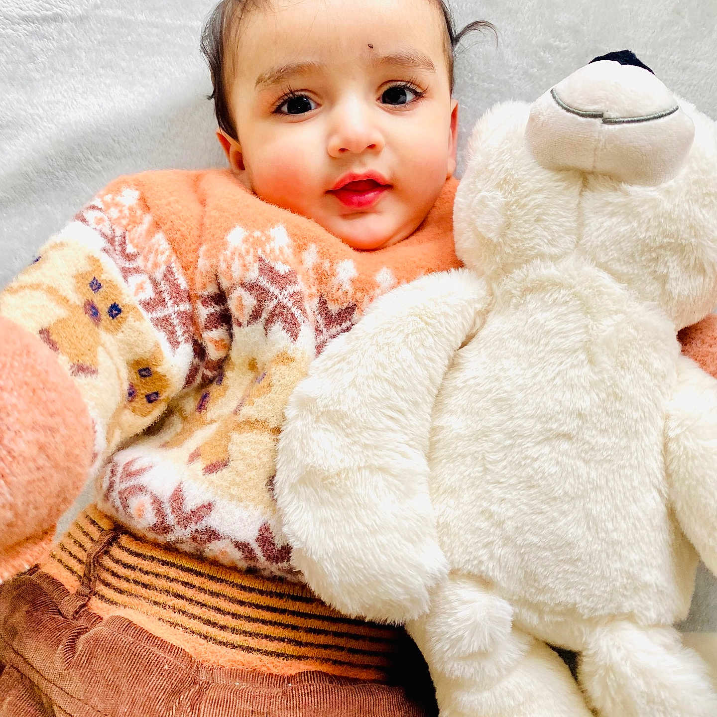 Jujhar joined the competition — help win amazing prizes! baby, brown_pants, child, closeup, cozy, cuddly, cute, happy, indoor, infant, patterned_clothing, person, plush_toy, portrait, smiling, soft_texture, sweater, teddy_bear, warm_clothing, white_background