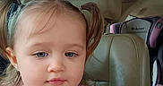 Sofia is registered to the contest to win money with this photo: car, car_interior, car_seat, child, child_safety_seat, close_up, eyes, face, girl, indoors, leather_seat, photograph, pigtails, pink_shirt, portrait, serious_expression, sitting, toddler, travel, vehicle