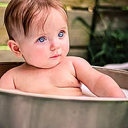 Hope joined the competition — help win amazing prizes! baby, child, blue_eyes, bath, tub, metal, skin, portrait, outdoor, wooden_background, curious, expression, water, young, infant, cute, relaxing, natural_light, closeup, sitting