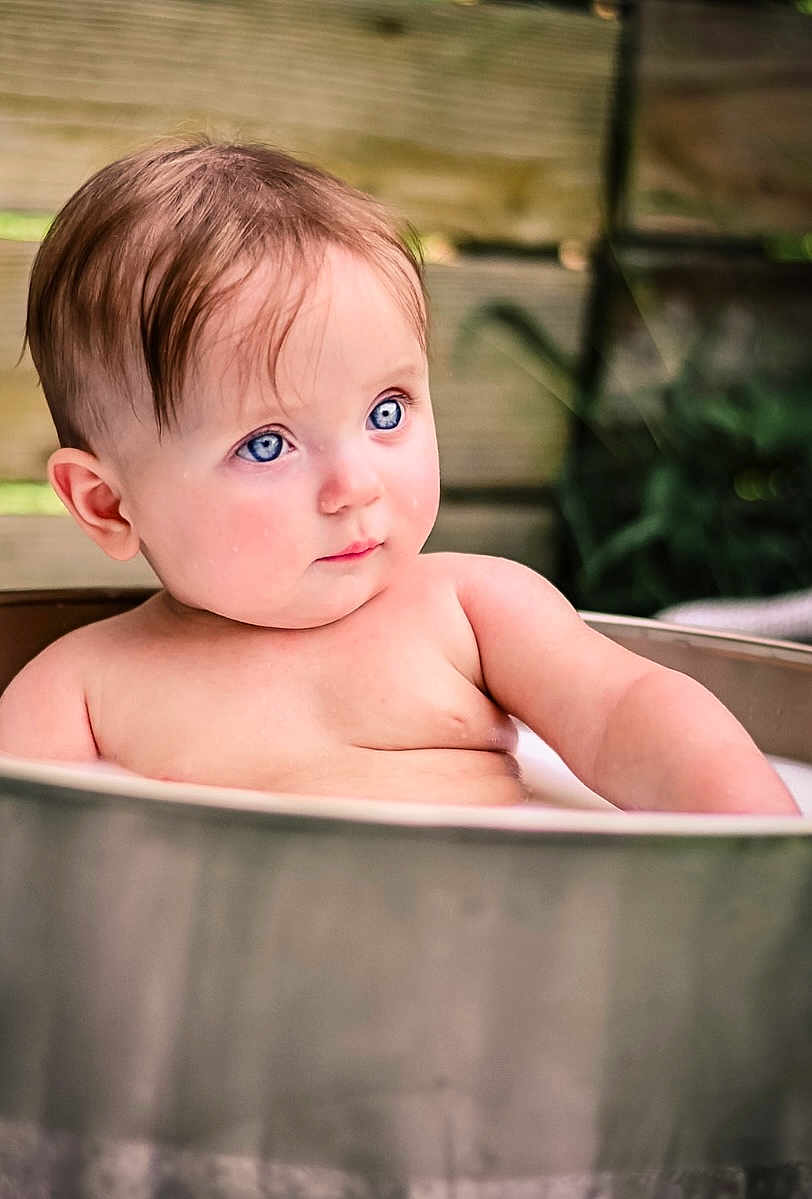 Hope joined the competition — help win amazing prizes! baby, child, blue_eyes, bath, tub, metal, skin, portrait, outdoor, wooden_background, curious, expression, water, young, infant, cute, relaxing, natural_light, closeup, sitting