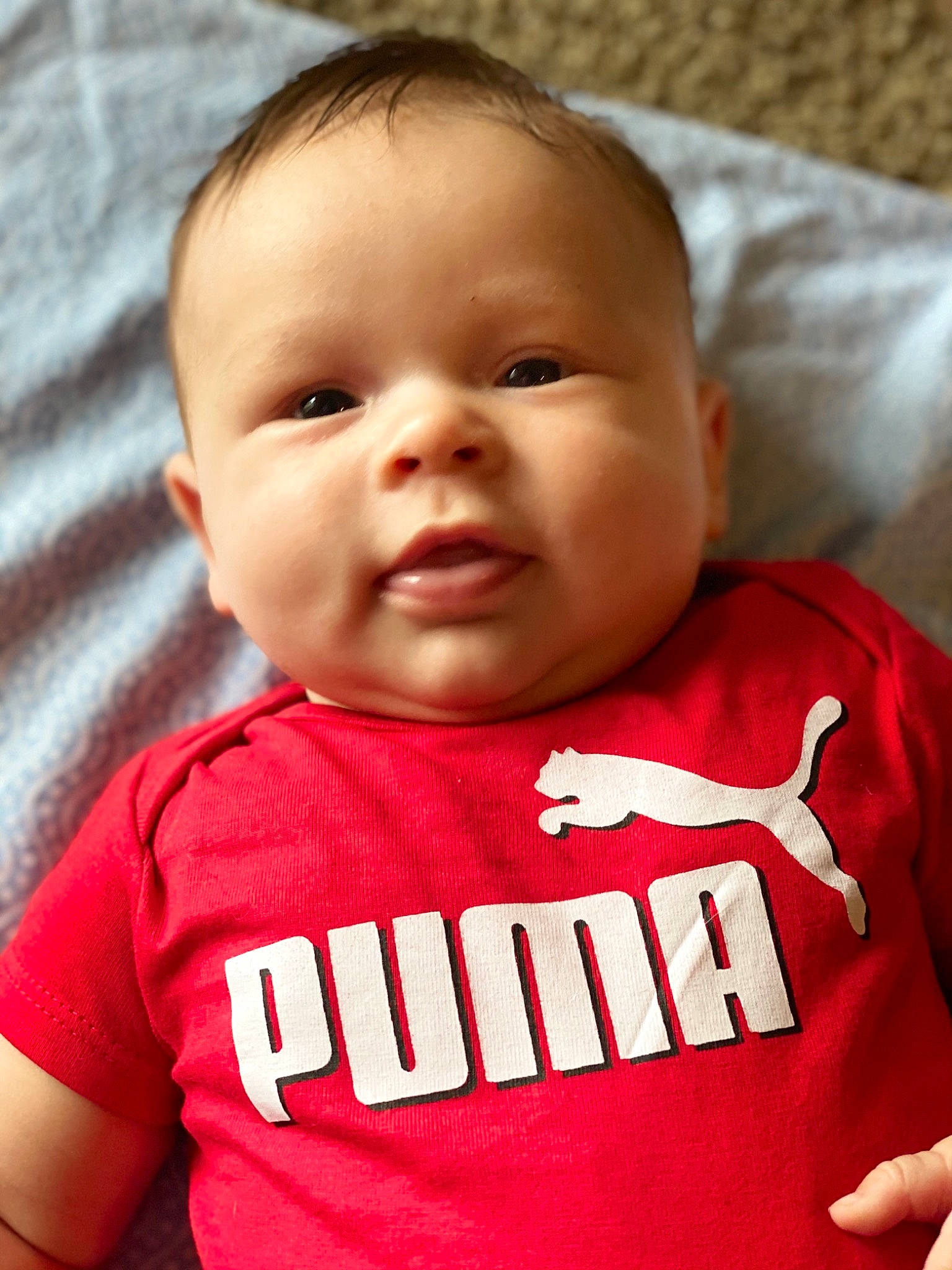 Lawrence is registered to the contest to win money with this photo: baby, baby_toddler_clothing, cheek, child, chin, face, facial_expression, head, lip, mouth, nose, person, red, skin, smile, t_shirt, toddler