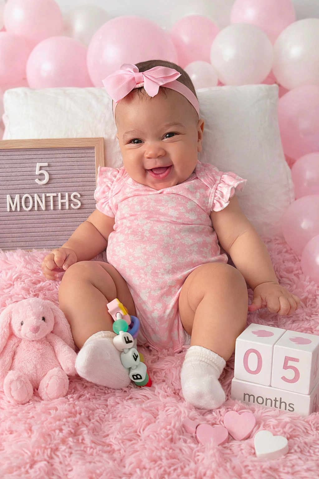 Lzyiah is registered to the contest to win money with this photo: baby, pink, smile, balloons, toy, blocks, bow, socks, fluffy_rug, milestone, infant, cute, happy, child, portrait, celebration, soft_toy, pink_outfit, headband, indoor