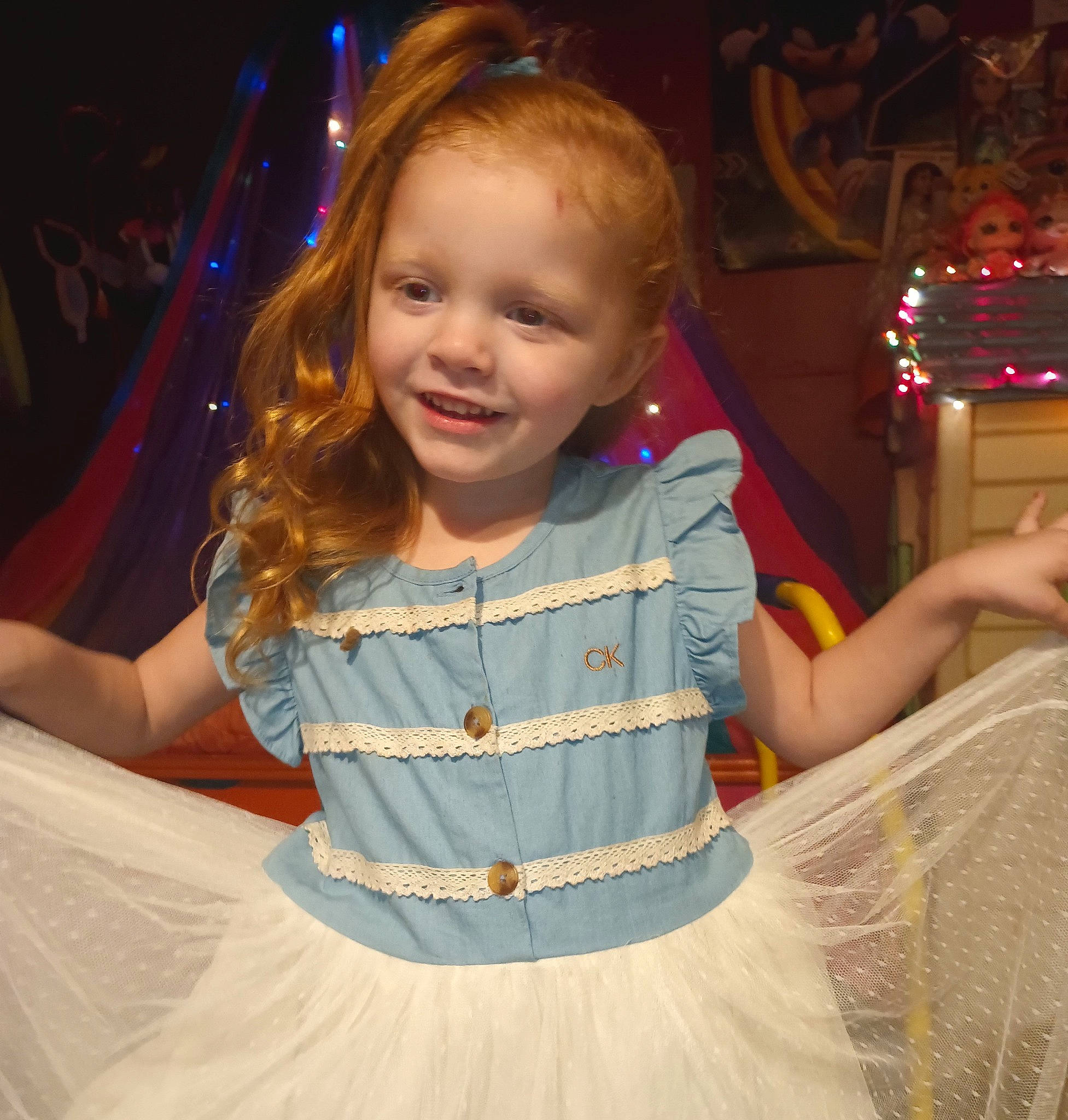 Starla is registered to the contest to win money with this photo: baby_toddler_clothing, blond, child, clothing, event, facial_expression, fun, hair, hairstyle, happy, head, human, human_body, iris, joy, person, sitting, sleeve, smile, standing