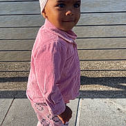 Maria joined the competition — help win amazing prizes! child, toddler, pink_clothing, headband, outdoor, river, cityscape, sidewalk, shadow, building, water, daylight, fashion, portrait, young_child, casual_wear, footwear, urban, smiling, person