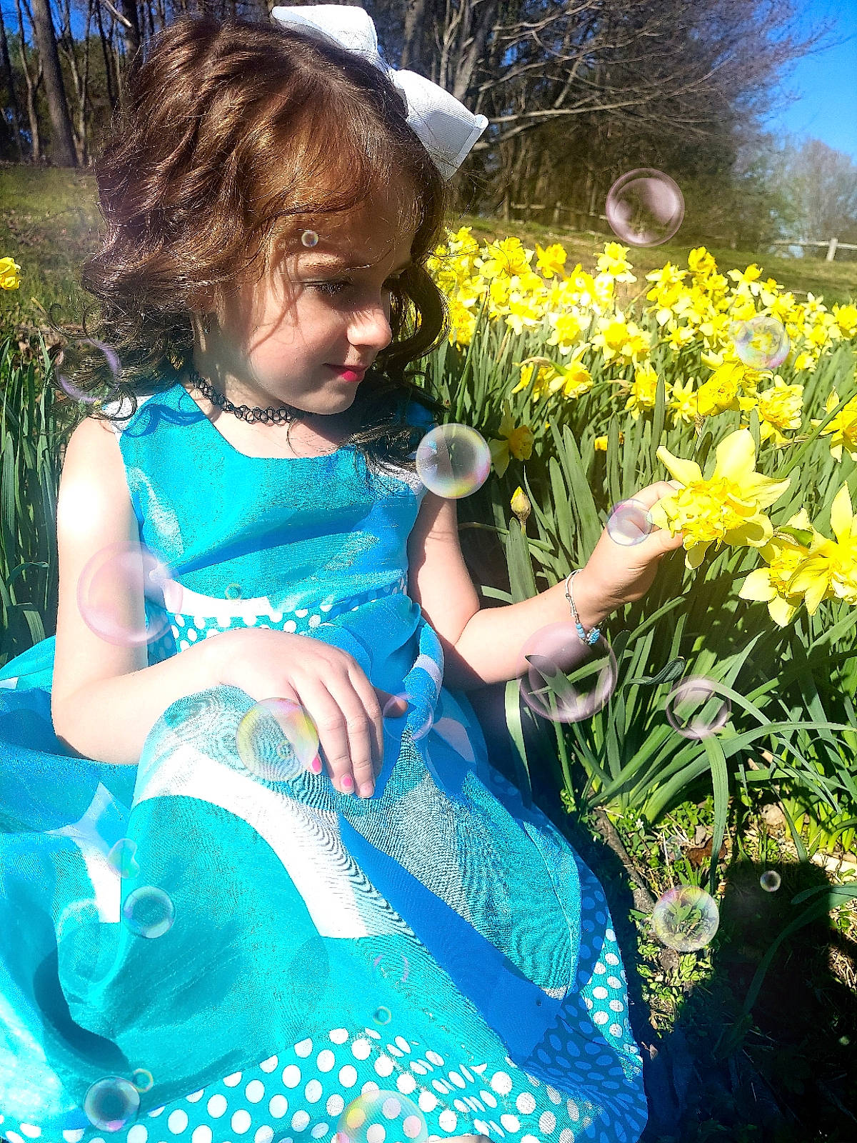 Haley joined the competition — help win amazing prizes! baby_toddler_clothing, blue, electric_blue, flower, fun, grass, grass_family, green, happy, leaf, meadow, natural_environment, people, people_in_nature, person, plant, summer, sunlight, toddler, tree