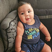 Levi is registered to the contest to win money with this photo: architecture, baby, building, chair, clothing, couch, cushion, face, furniture, head, homedecor, pants, person, photography, pillow, portrait, shorts, sitting, t_shirt, tanktop