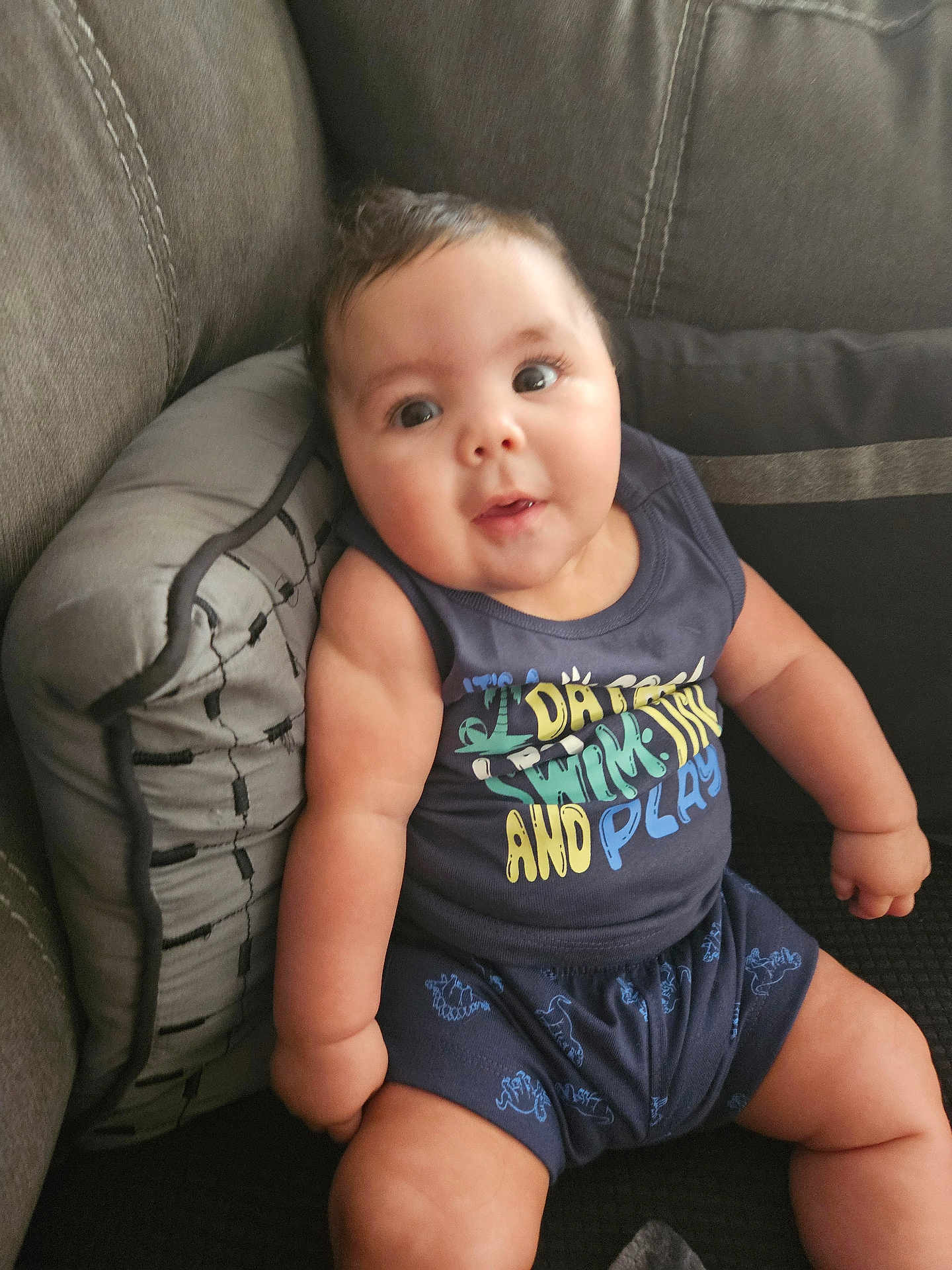 Levi is registered to the contest to win money with this photo: architecture, baby, building, chair, clothing, couch, cushion, face, furniture, head, homedecor, pants, person, photography, pillow, portrait, shorts, sitting, t_shirt, tanktop