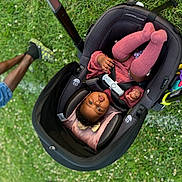 Jordyn joined the competition — help win amazing prizes! baby, stroller, infant, pink_socks, pink_clothing, grass, outdoor, child, legs, person, pavement, carrying_handle, seat_belt, toy, cute, pouting, relaxed, park, daylight, casual