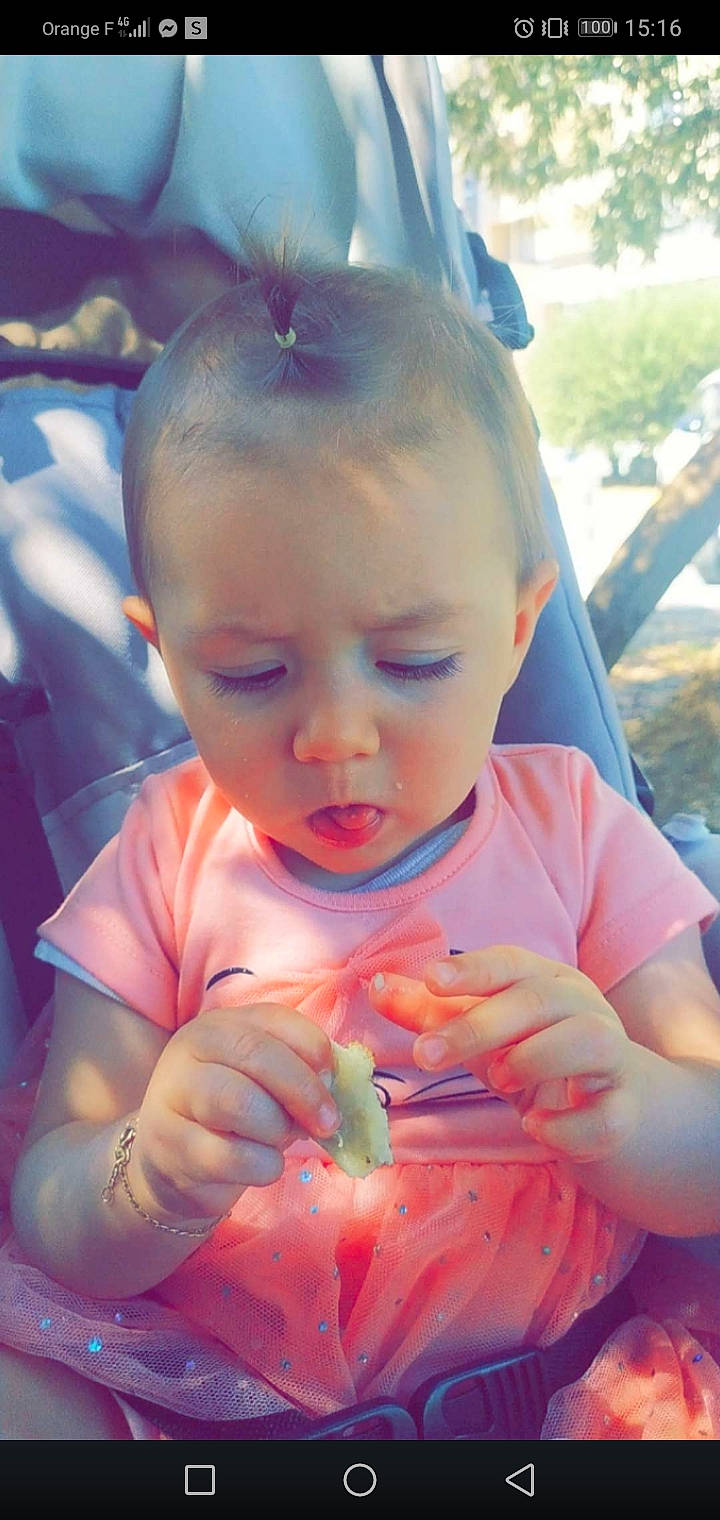 Alexia participe au concours pour gagner de l'argent avec cette photo : baby_toddler_clothing, cheek, dress, face, facial_expression, finger, grass, happy, head, iris, leaf, lip, mouth, nose, orange, person, pink, plant, product, skin