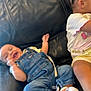 baby, candid, casual, child, denim_overalls, furniture, hair_braids, happy, home, indoor, leather_couch, people, playful, sitting, smiling, socks, striped_shirt, toddler, two_children, yellow_shorts