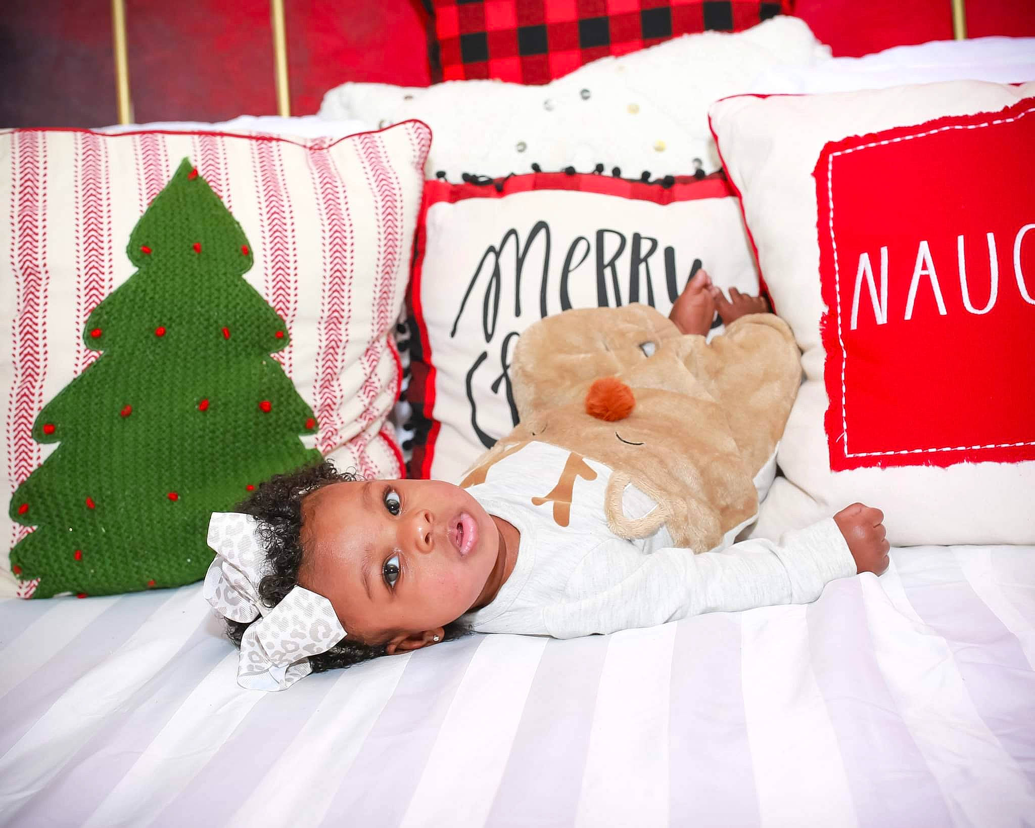 Lailonni joined the competition — help win amazing prizes! baby, baby_toddler_clothing, bed_sheet, bedding, carmine, christmas_tree, comfort, conifer, event, evergreen, happy, holiday, linens, pattern, person, pillow, plant, red, room, throw_pillow