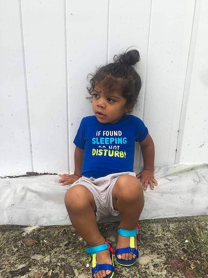 Julian is registered to the contest to win money with this photo: arm, child, clothing, electric_blue, grass, hand, happy, human_body, human_leg, knee, leg, leisure, person, shorts, sportswear, street_fashion, t_shirt, thigh, toddler, water