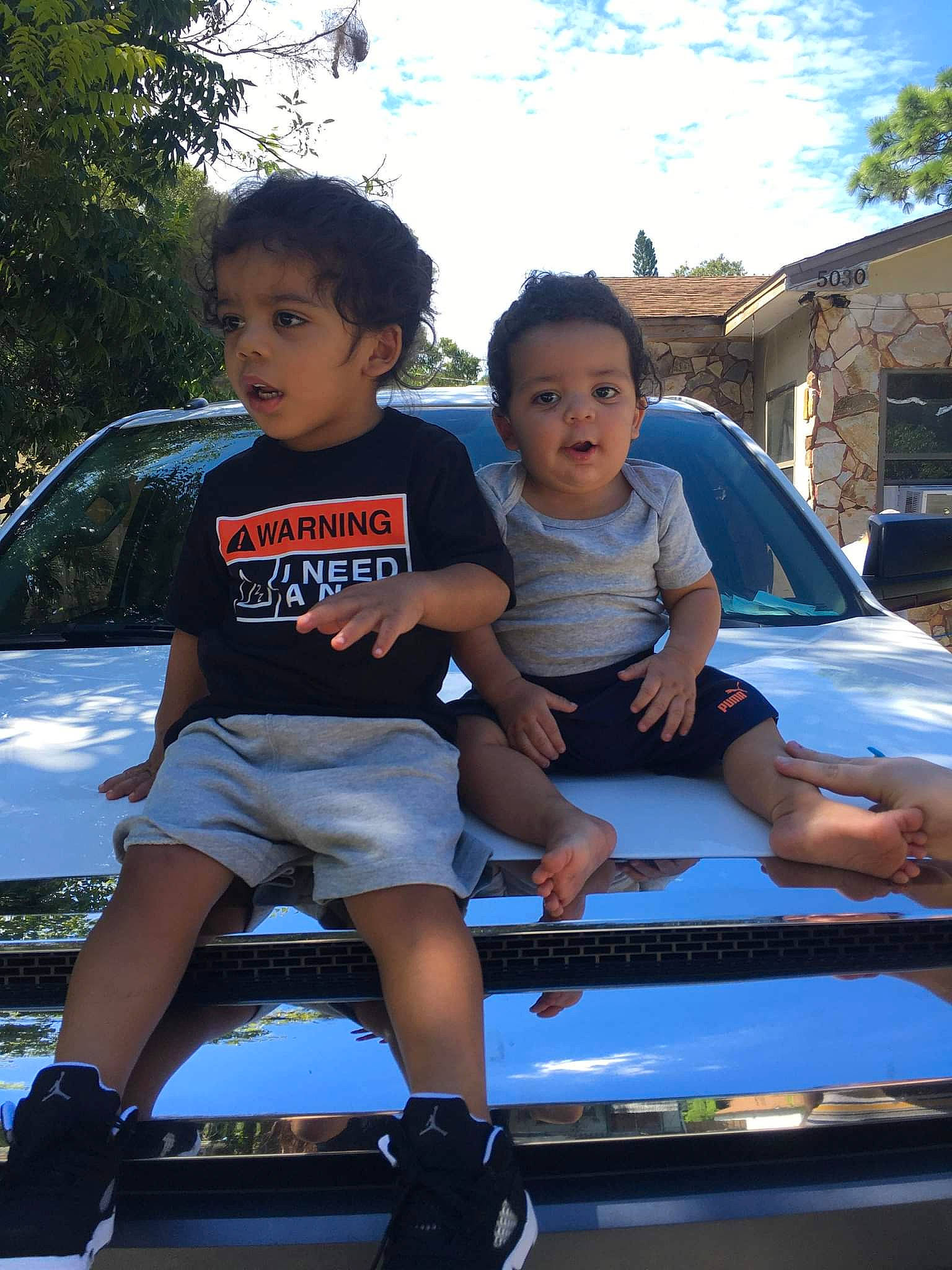 Julian joined the competition — help win amazing prizes! automotive_design, automotive_exterior, automotive_lighting, bumper, car, facial_expression, fun, happy, hood, land_vehicle, leisure, mode_of_transport, motor_vehicle, person, shorts, sky, t_shirt, toddler, tree, vehicle