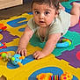 Emilio participe au concours pour gagner de l'argent avec cette photo : baby, child, toy, colorful, foam_mat, floor, wooden_floor, indoor, playtime, curious, infant, crawling, cute, person, small_toy, plastic_toy, bright_colors, mat, expression, home