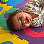 Emilio participe au concours pour gagner de l'argent avec cette photo : baby, child, smiling, foam_mat, colorful, toy, playtime, indoor, floor, puzzle_mat, happy, infant, cushion, pattern, clothing, cute, head, person, toddler, play