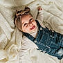 Odayah joined the competition — help win amazing prizes! baby, smiling, headband, bow, denim_overalls, blanket, knitted, happy, child, infant, cute, tongue_out, clothing, portrait, lying_down, soft_texture, warm_colors, person, indoors, playful