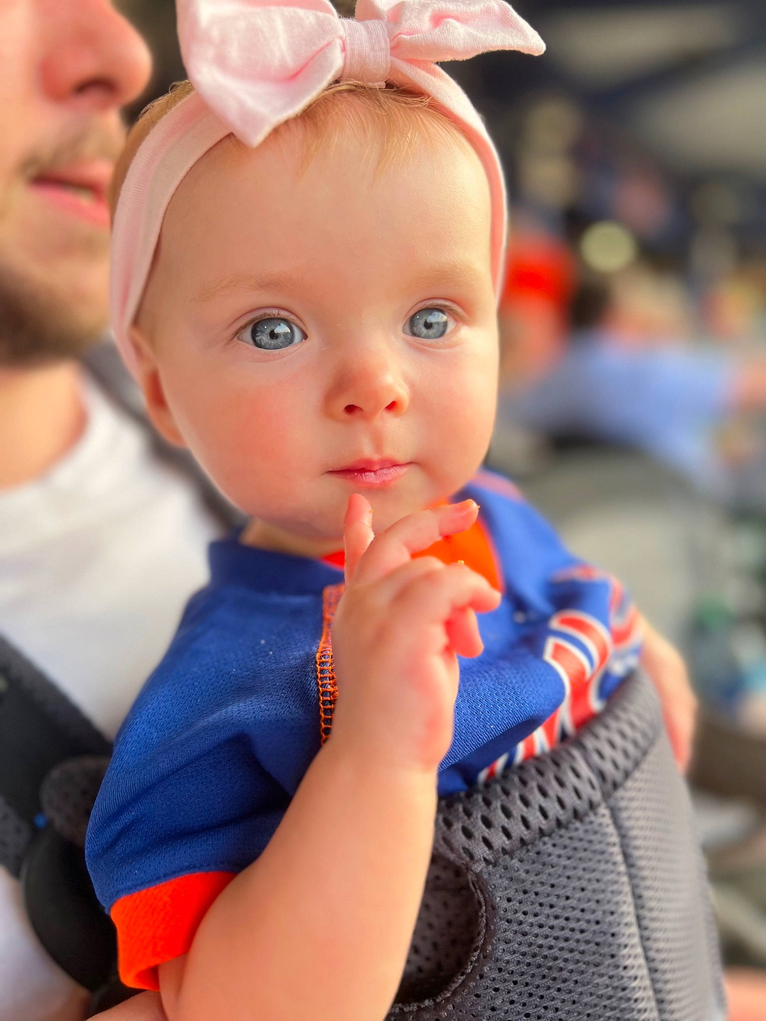 Lena is registered to the contest to win money with this photo: arm, baby, baby_toddler_clothing, blond, child, dress, ear, electric_blue, event, eyelash, fashion_accessory, gesture, hand, happy, human_body, iris, lip, neck, person, skin