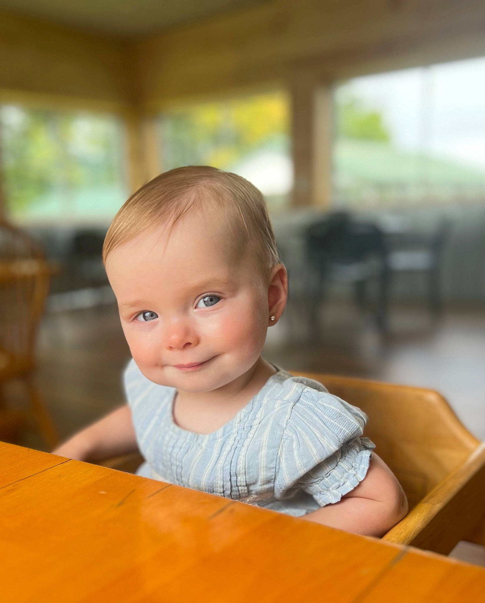 Lena is registered to the contest to win money with this photo: baby, baby_toddler_clothing, chair, cheek, child, chin, face, flooring, fun, furniture, happy, hardwood, iris, joy, leisure, person, skin, smile, table, toddler