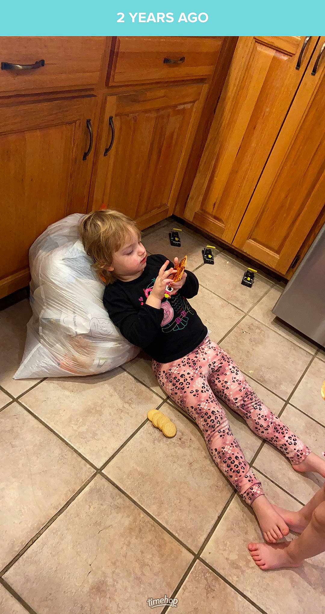 Isabella is registered to the contest to win money with this photo: boot, cabinetry, comfort, floor, flooring, foot, hardwood, human_leg, kitchen, knee, laminate_flooring, leg, long_hair, person, shoulder, sitting, thigh, waist, wood, wood_flooring