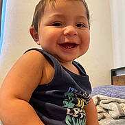 Javier joined the competition — help win amazing prizes! baby, babylaughing, bodypart, clothing, face, furniture, happy, head, indoors, laughing, mouth, person, photoframe, photography, portrait, sitting, smile, t_shirt, tanktop, teeth