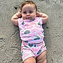 baby, child, sand, beach, clothing, heart_pattern, shorts, shirt, sock, relaxed, cute, outdoor, person, infant, legs, arms, skin, footwear, playful, summer