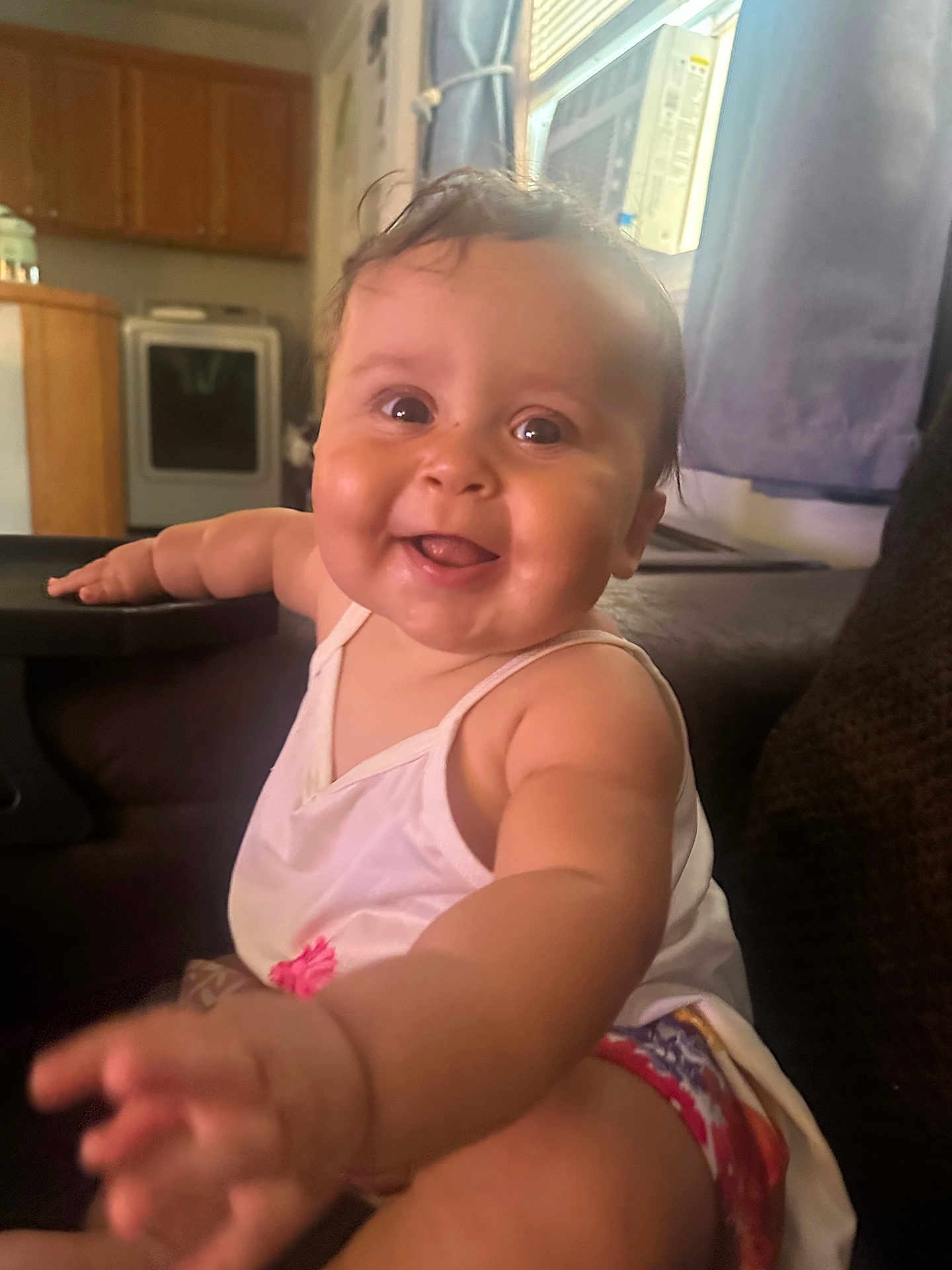 Monroe joined the competition — help win amazing prizes! baby, child, smiling, indoor, kitchen, window, curtain, arm, face, happy, person, couch, clothing, sitting, cute, infant, skin, hair, eyes, hand