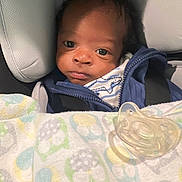 Cason is registered to the contest to win money with this photo: baby, infant, car_seat, blanket, pacifier, blue_jacket, face, child, young, indoors, seated, clothing, closeup, person, cute, baby_boy, expression, comfort, car, portrait