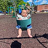 baby, swing, playground, child, outdoor, daylight, blue_sky, green, seat, equipment, expressionless, summer, park, infant, clothing, legs, feet, shadow, background, trees