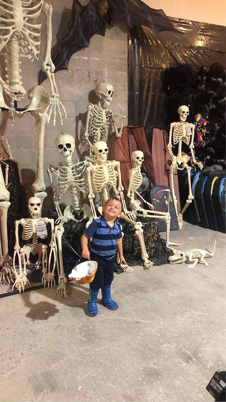 Zane is registered to the contest to win money with this photo: anthropology, art, bag, collection, event, fashion_design, flooring, fossil, fun, joy, leisure, luggage_and_bags, person, public_space, retail, room, sitting, skeleton, skull, theatrical_property