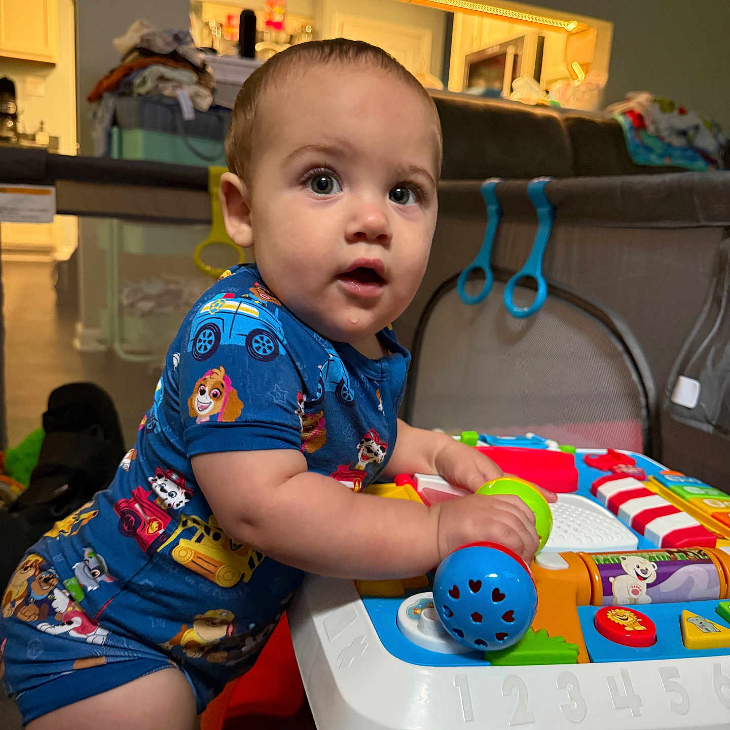 Jt joined the competition — help win amazing prizes! toddler, child, baby, onesie, paw_patrol, toy, activity_table, drool, curious, indoor, living_room, couch, play, colorful, cute, person, face, expression, furniture, home