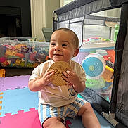 Jt joined the competition — help win amazing prizes! baby, child, indoor, playpen, toys, colorful, foam_mats, smiling, wooden_plaque, storage_bin, window, daylight, happy, sitting, clothing, shorts, tshirt, floor, playroom, person