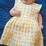 baby, blue_blanket, checkered_pattern, child, clothing, cute, dress, foot, hand, happy, infant, lying_down, person, portrait, skin, smiling, soft, texture, white, yellow