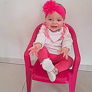 Mya a rejoint le concours — aidez-le/la à gagner de superbes lots ! baby, infant, child, smiling, pink_headband, flower_headband, pink_chair, plastic_chair, bib, pink_pants, socks, white_wall, tile_floor, indoor, portrait, cute, happy, reaching, one_person, toddler