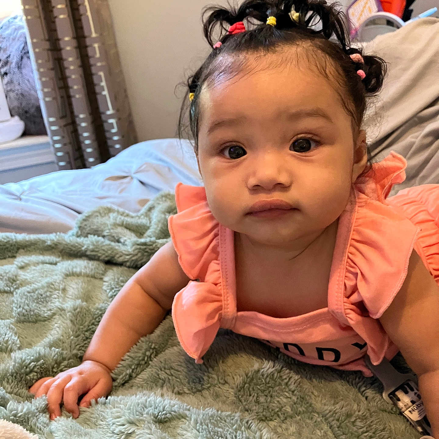 Yazlyn joined the competition — help win amazing prizes! baby, bedroom, blanket, child, colorful_hair_bands, cozy, curtains, cute, expression, face, hand, homely, indoor, infant, lying_down, pacifier, pigtails, pink_clothing, portrait, soft_texture