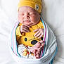Oscar Balderrama joined the competition — help win amazing prizes! newborn, baby, sleeping, blanket, yellow_hat, yellow_clothing, wrapped, cute, infant, soft, peaceful, portrait, indoors, closeup, human, child, cozy, tiny_feet, hand, face