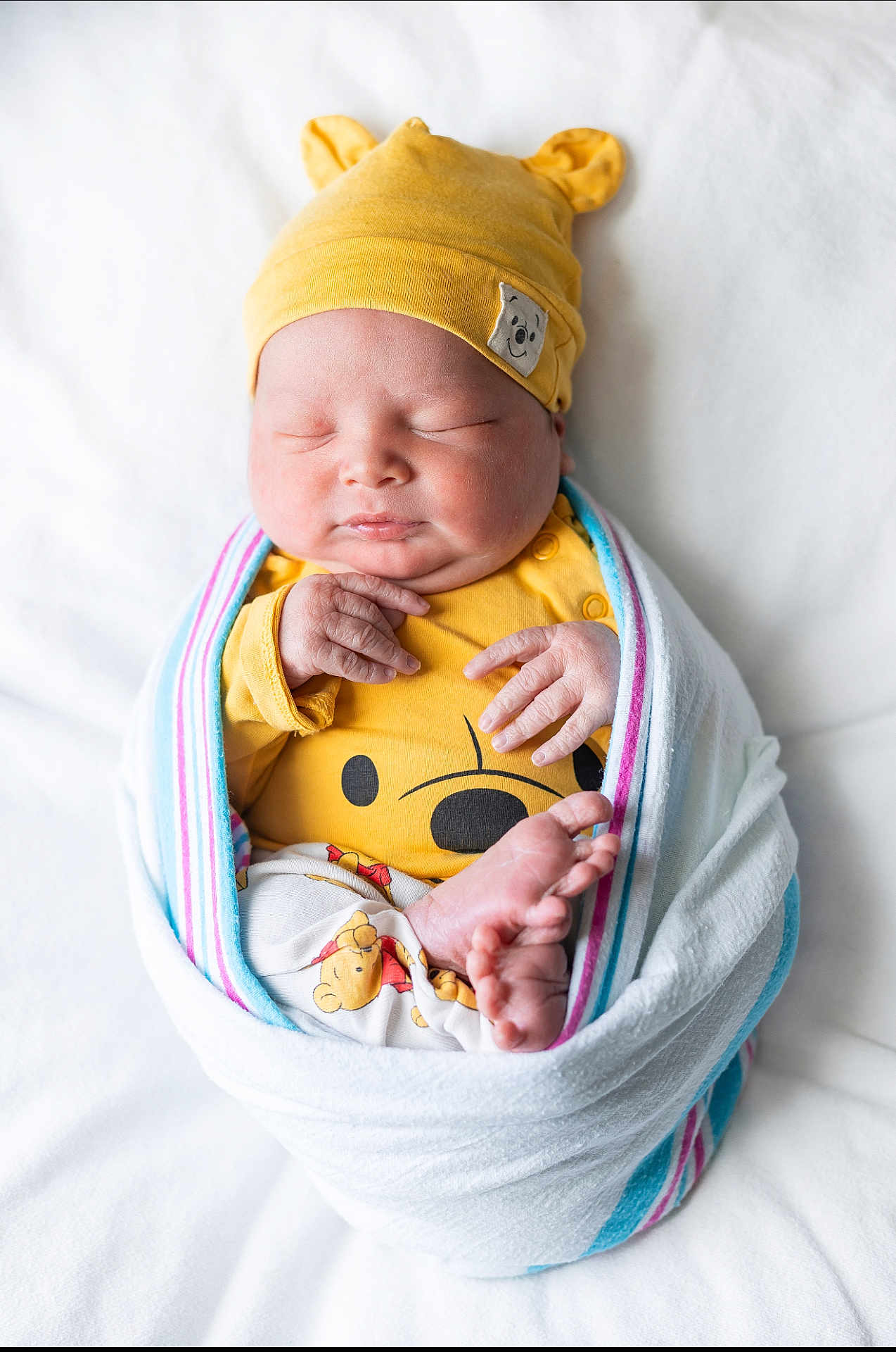 Oscar Balderrama joined the competition — help win amazing prizes! newborn, baby, sleeping, blanket, yellow_hat, yellow_clothing, wrapped, cute, infant, soft, peaceful, portrait, indoors, closeup, human, child, cozy, tiny_feet, hand, face