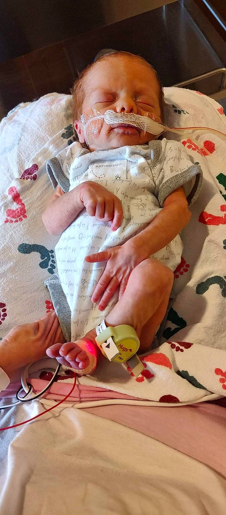 Madison is registered to the contest to win money with this photo: baby, carmine, child, comfort, eye, finger, foot, hat, head, human_leg, knee, linens, nail, patient, person, skin, textile, thigh, thumb, wrinkle