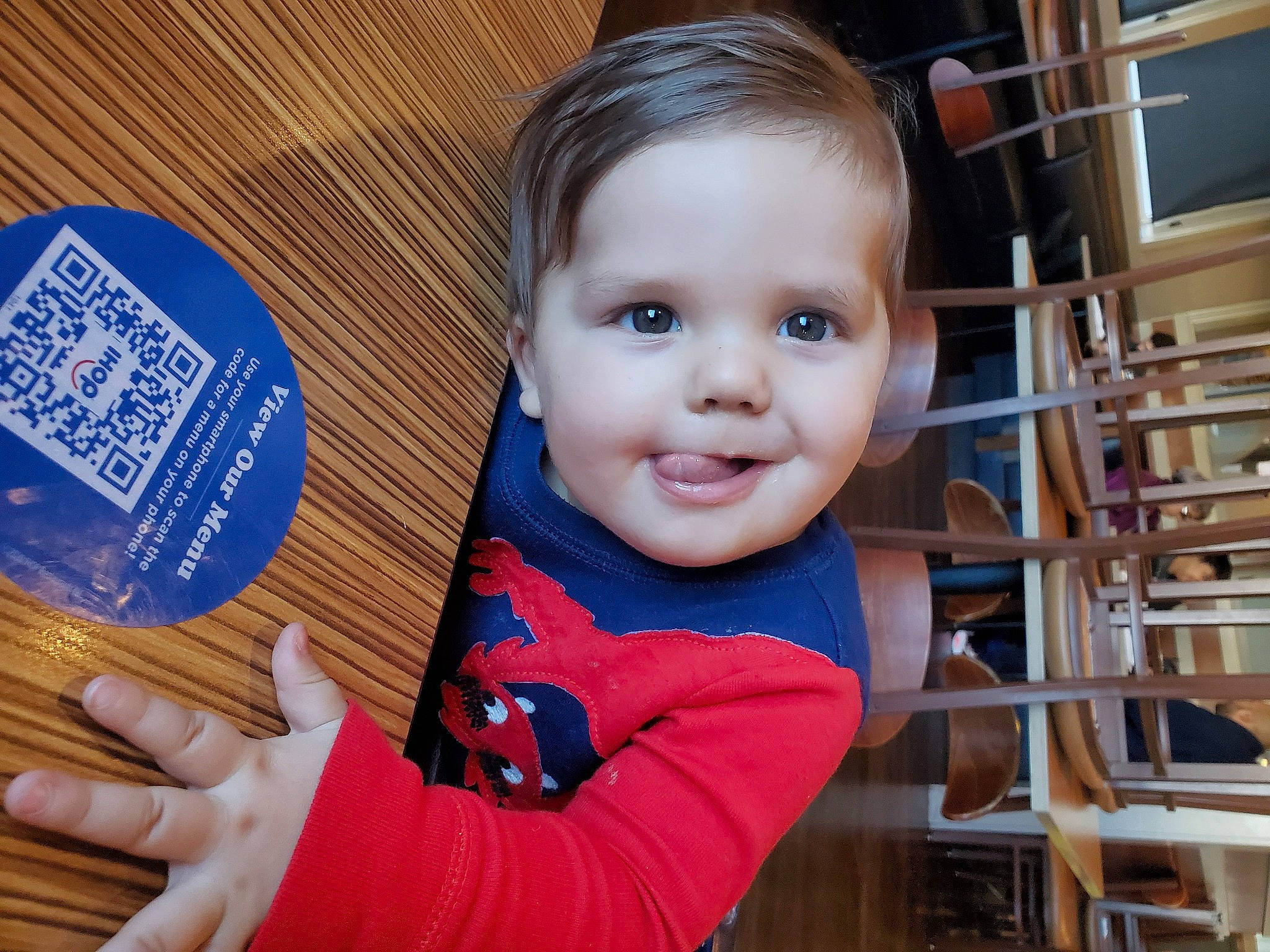 Wyatt is registered to the contest to win money with this photo: baby, baby_toddler_clothing, chair, cheek, child, electric_blue, finger, font, gesture, happy, joy, laugh, nail, person, sitting, skin, smile, t_shirt, thumb, toddler