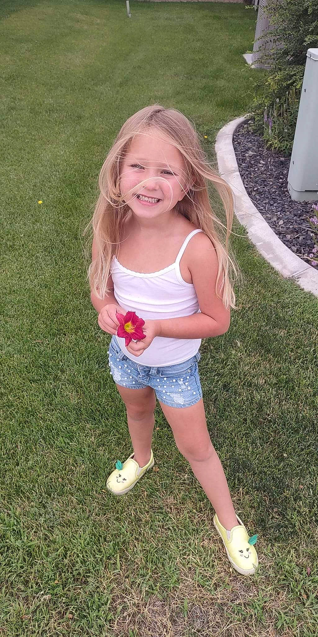 Brynnley is registered to the contest to win money with this photo: baby_toddler_clothing, eye, face, footwear, fun, grass, happy, joy, leisure, meadow, people_in_nature, person, pink, plant, recreation, shorts, smile, t_shirt, thigh, toddler