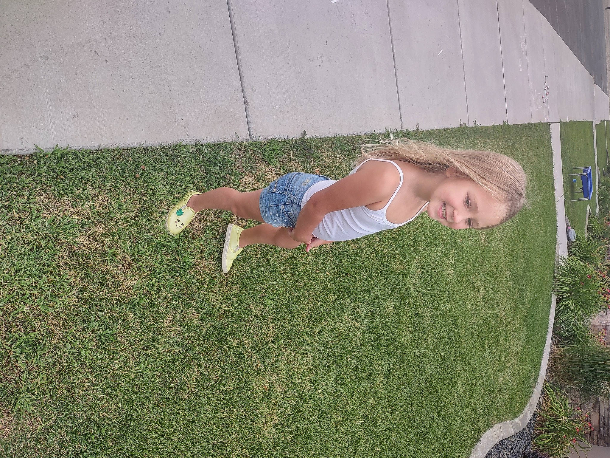 Brynnley is registered to the contest to win money with this photo: flooring, fun, garden, grass, grass_family, grassland, human_leg, joy, knee, landscape, lawn, leisure, people_in_nature, person, plant, recreation, sidewalk, soil, t_shirt, thigh