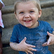 Jaxon is registered to the contest to win money with this photo: child, boy, smiling, blue_shirt, dusty, hands, face, short_hair, outdoor, steps, happy, casual_clothing, portrait, cute, playful, daylight, young, person, skin, expression