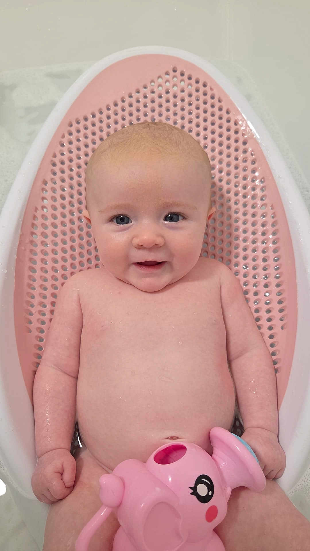 Felicity is registered to the contest to win money with this photo: baby, infant, bath, bathroom, pink, toy, elephant_toy, water, seat, child, skin, cute, smiling, happy, toddler, playful, sitting, face, head, arm