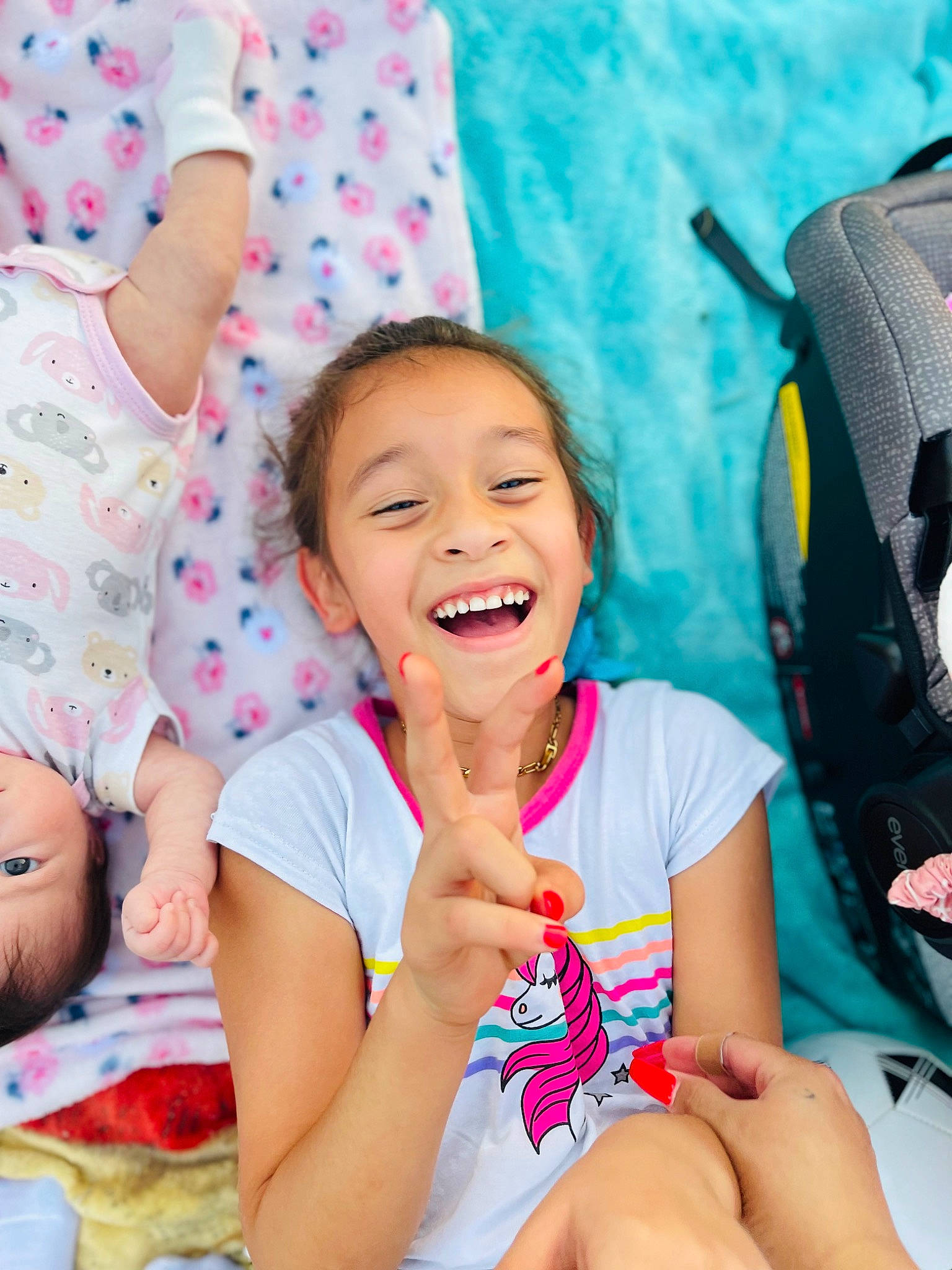 Aleynah is registered to the contest to win money with this photo: baby_toddler_clothing, child, comfort, event, face, finger, foot, fun, gesture, happy, joy, leisure, nail, pattern, person, pink, sitting, skin, smile, thigh